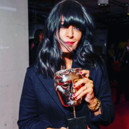 Claudia Winkleman took a picture as she posed with a Bafta award.